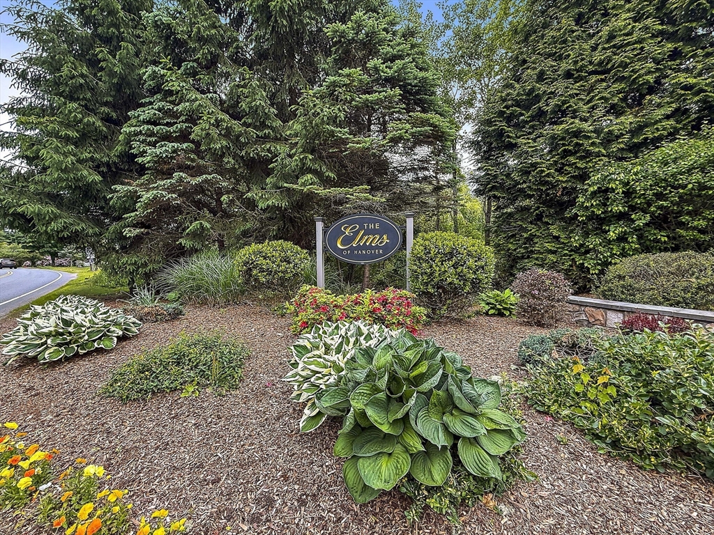 14 Sugar Maple Circle, Unit 14 Hanover, MA 02339 - Photo 2 of 38 a sign that is sitting in the middle of garden