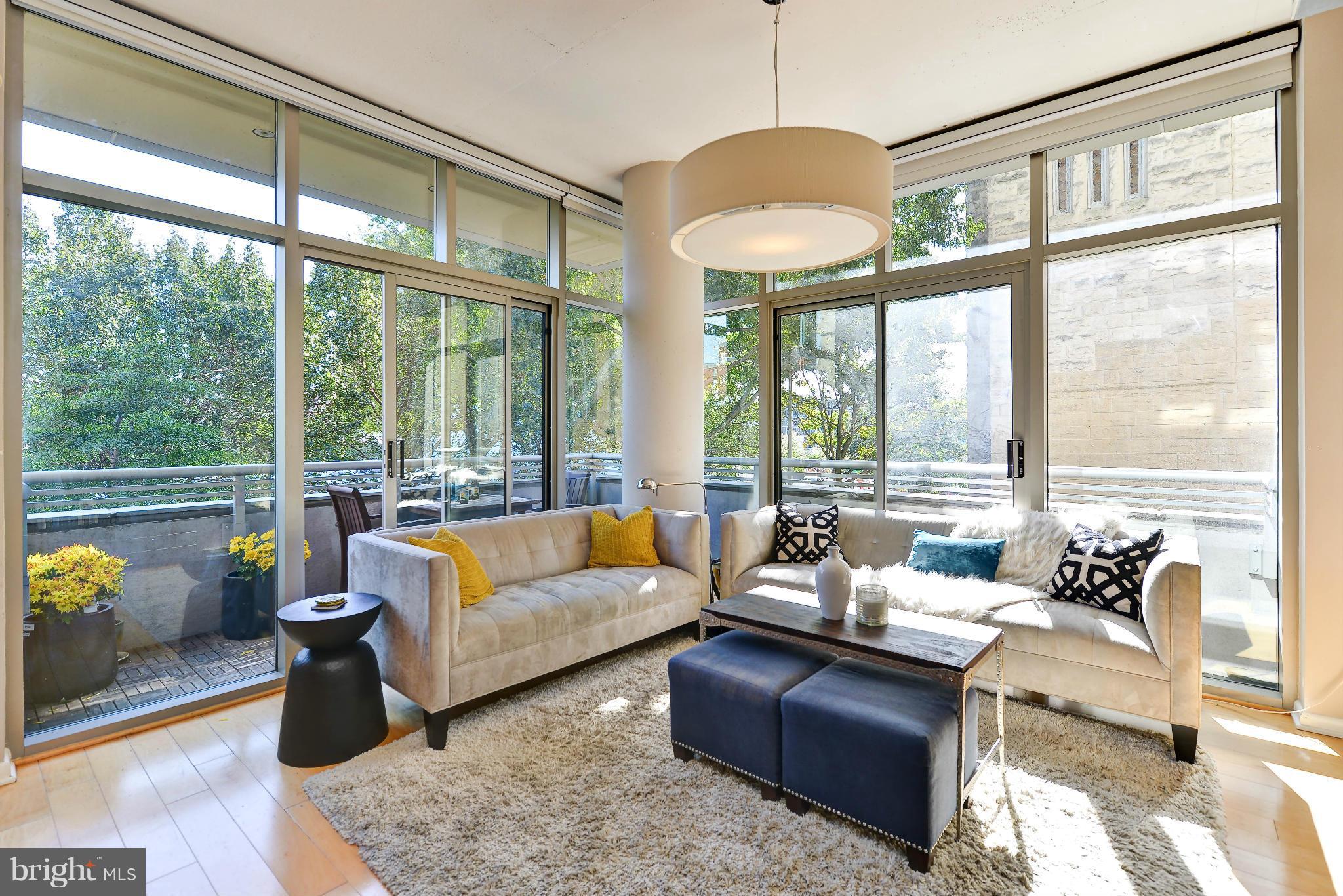 811 4th Street Northwest, Unit 218 Washington, DC 20001 - Photo 1 of 28 a living room with furniture and floor to ceiling windows