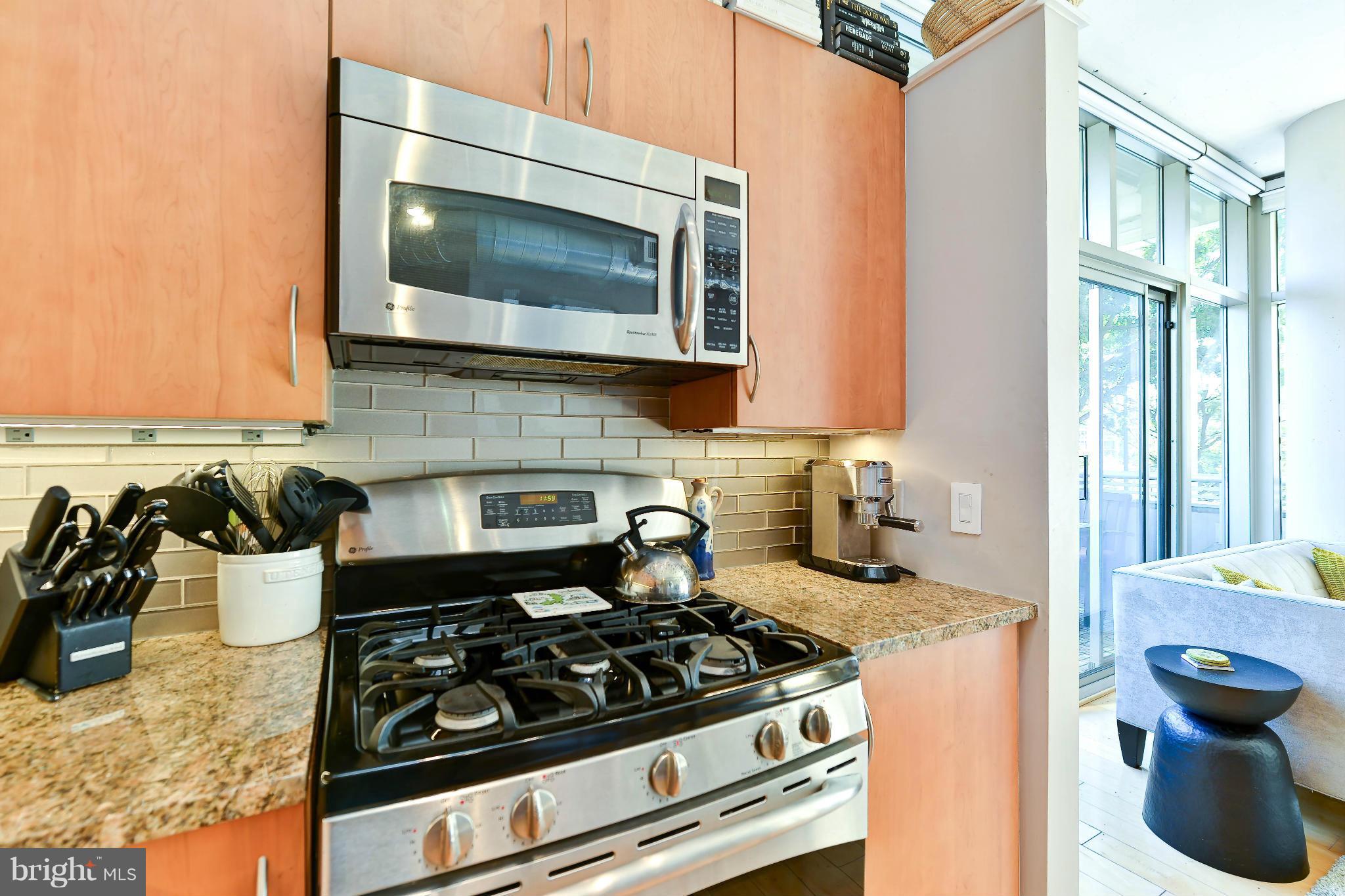 811 4th Street Northwest, Unit 218 Washington, DC 20001 - Photo 11 of 28 a kitchen with a stove and a microwave