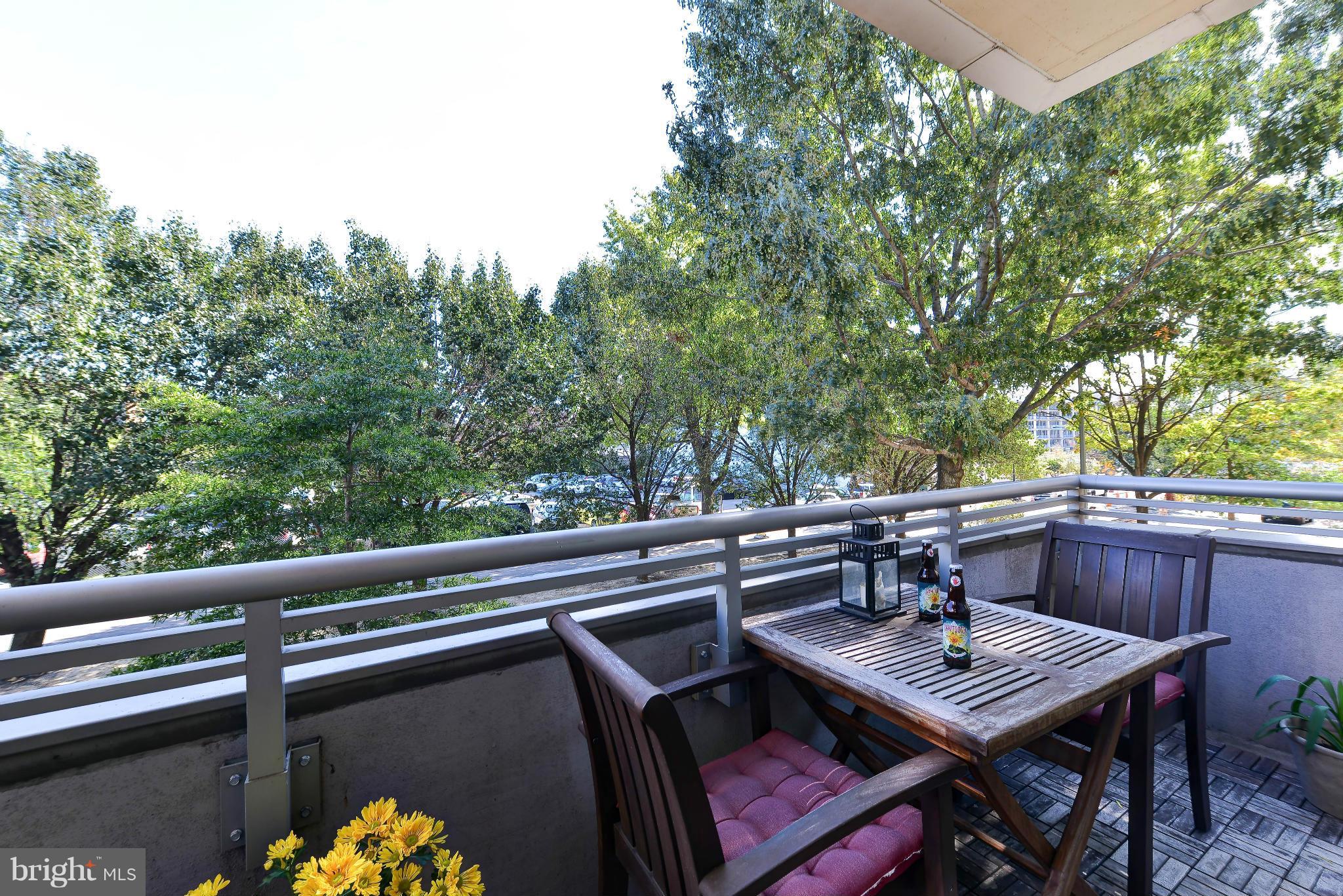 811 4th Street Northwest, Unit 218 Washington, DC 20001 - Photo 12 of 28 a view of a balcony with table and chairs and couches