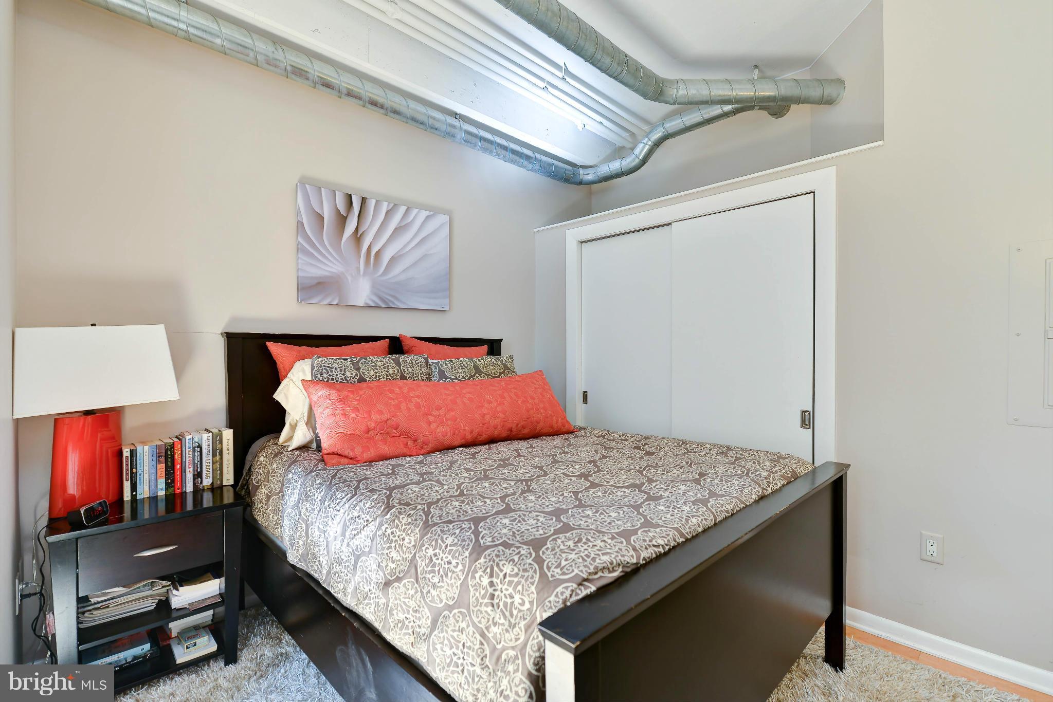 811 4th Street Northwest, Unit 218 Washington, DC 20001 - Photo 15 of 28 a bedroom with a bed and a night stand