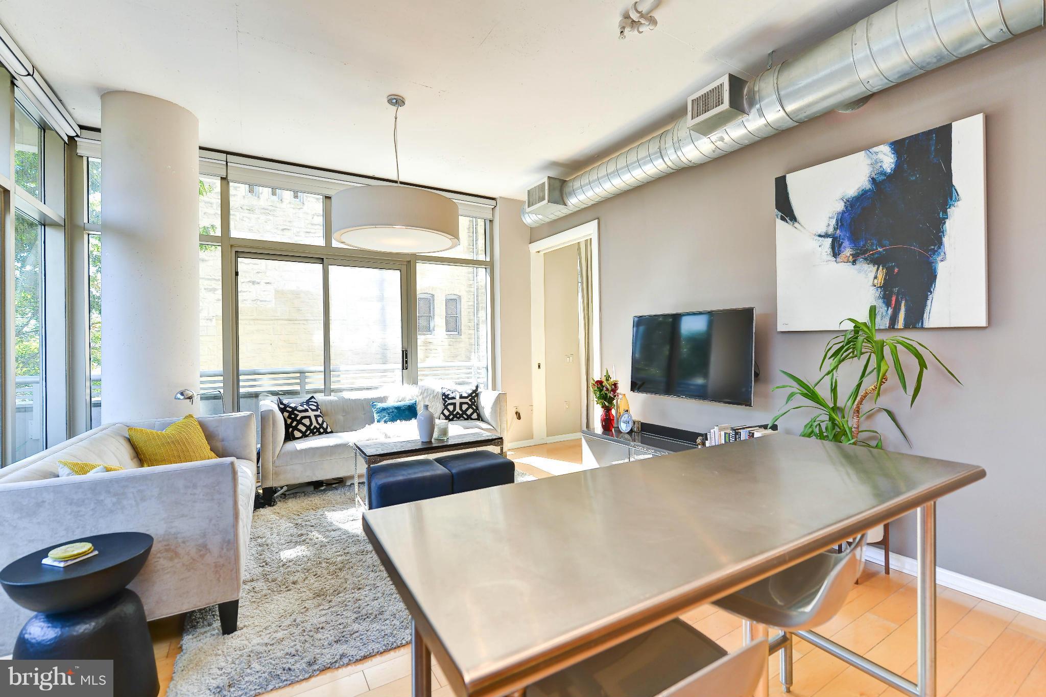 811 4th Street Northwest, Unit 218 Washington, DC 20001 - Photo 3 of 28 a living room with furniture and a flat screen tv