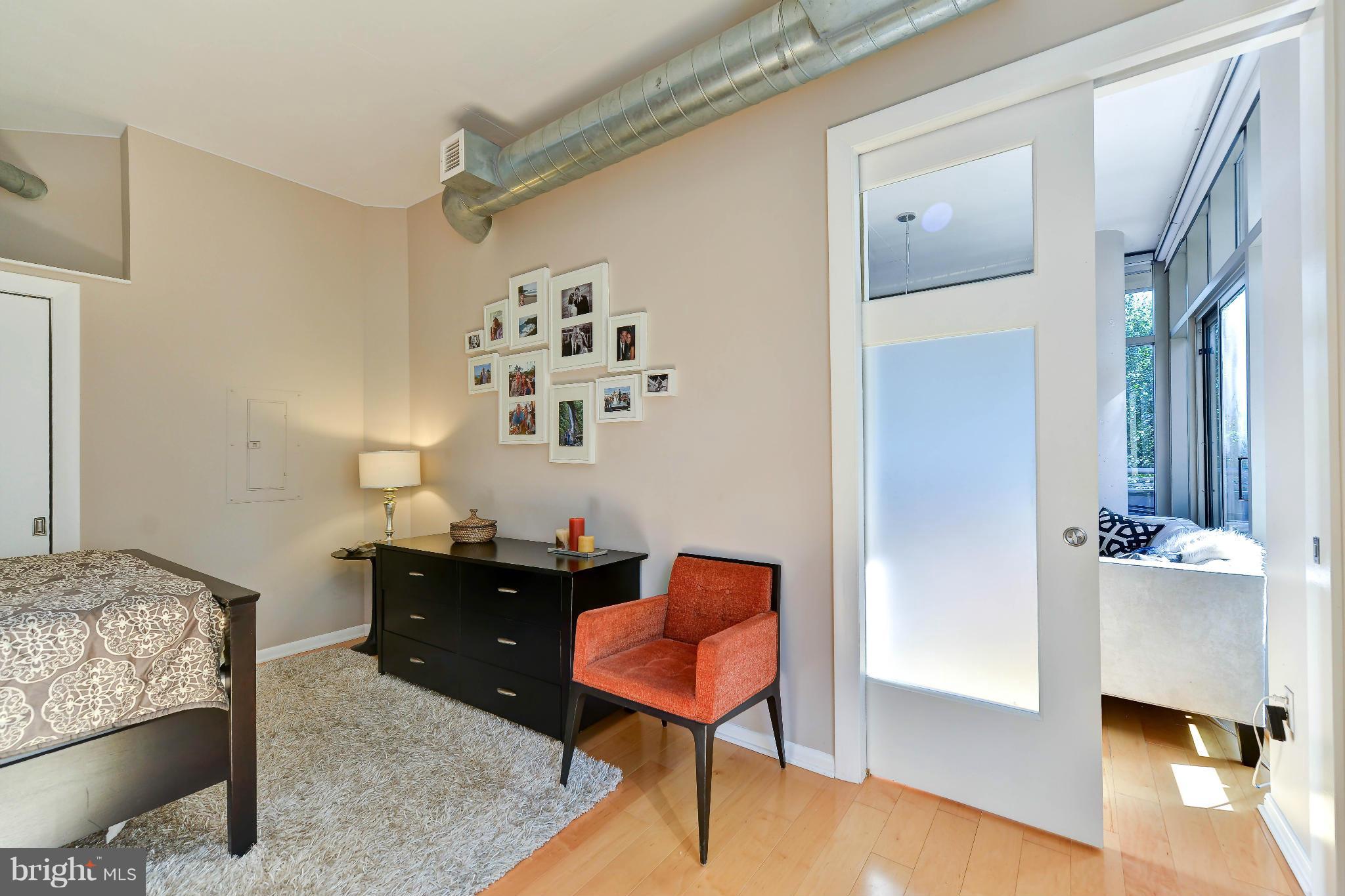 811 4th Street Northwest, Unit 218 Washington, DC 20001 - Photo 21 of 28 a living room with furniture and a chair