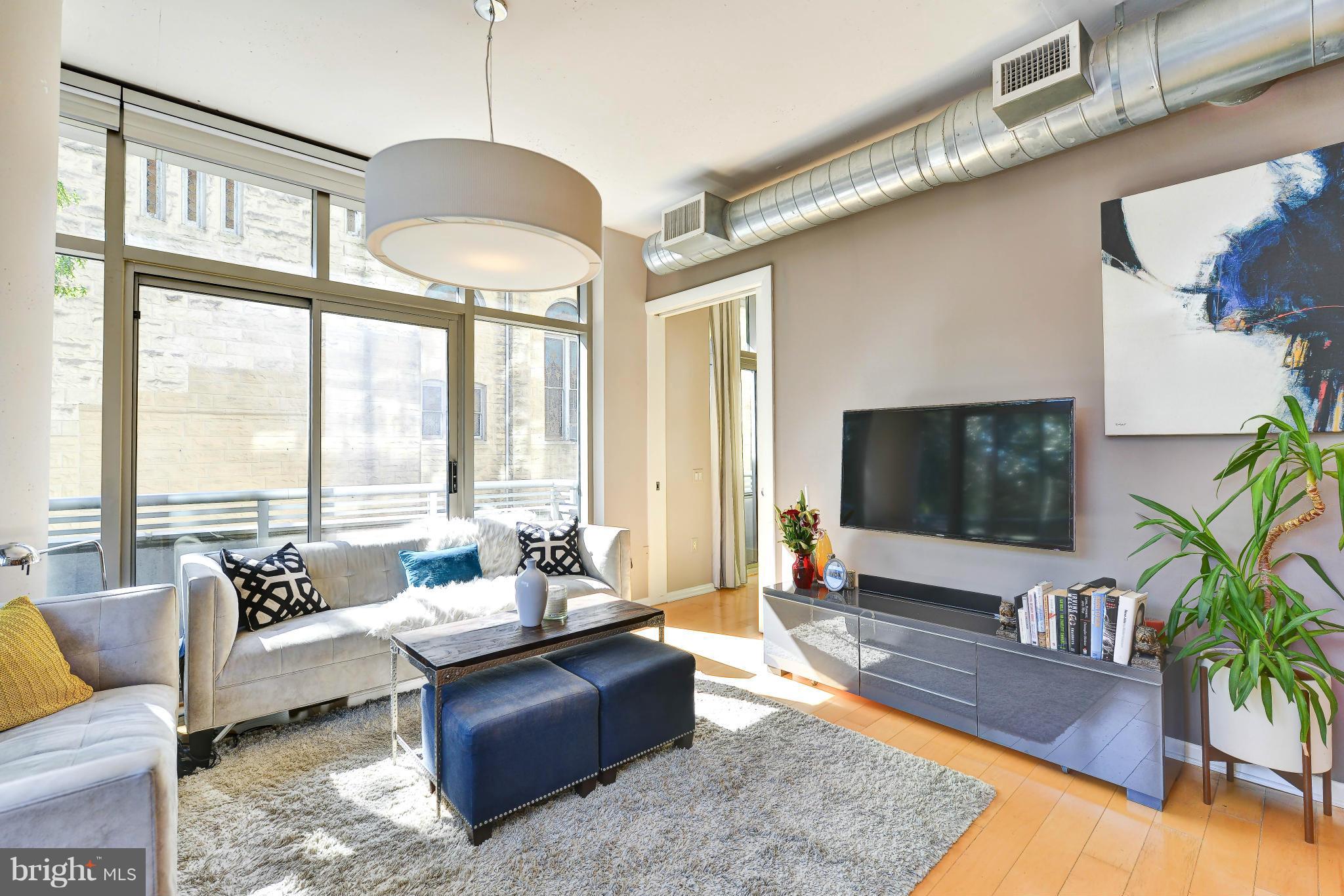 811 4th Street Northwest, Unit 218 Washington, DC 20001 - Photo 4 of 28 a living room with furniture and a flat screen tv