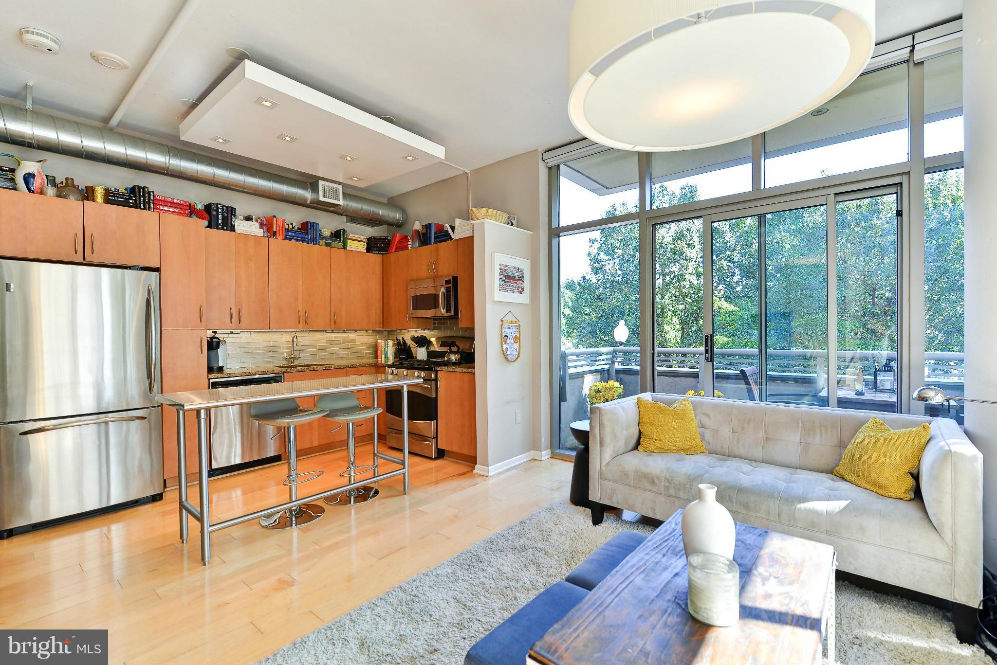 811 4th Street Northwest, Unit 218 Washington, DC 20001 - Photo 6 of 28 a living room with furniture and a large window