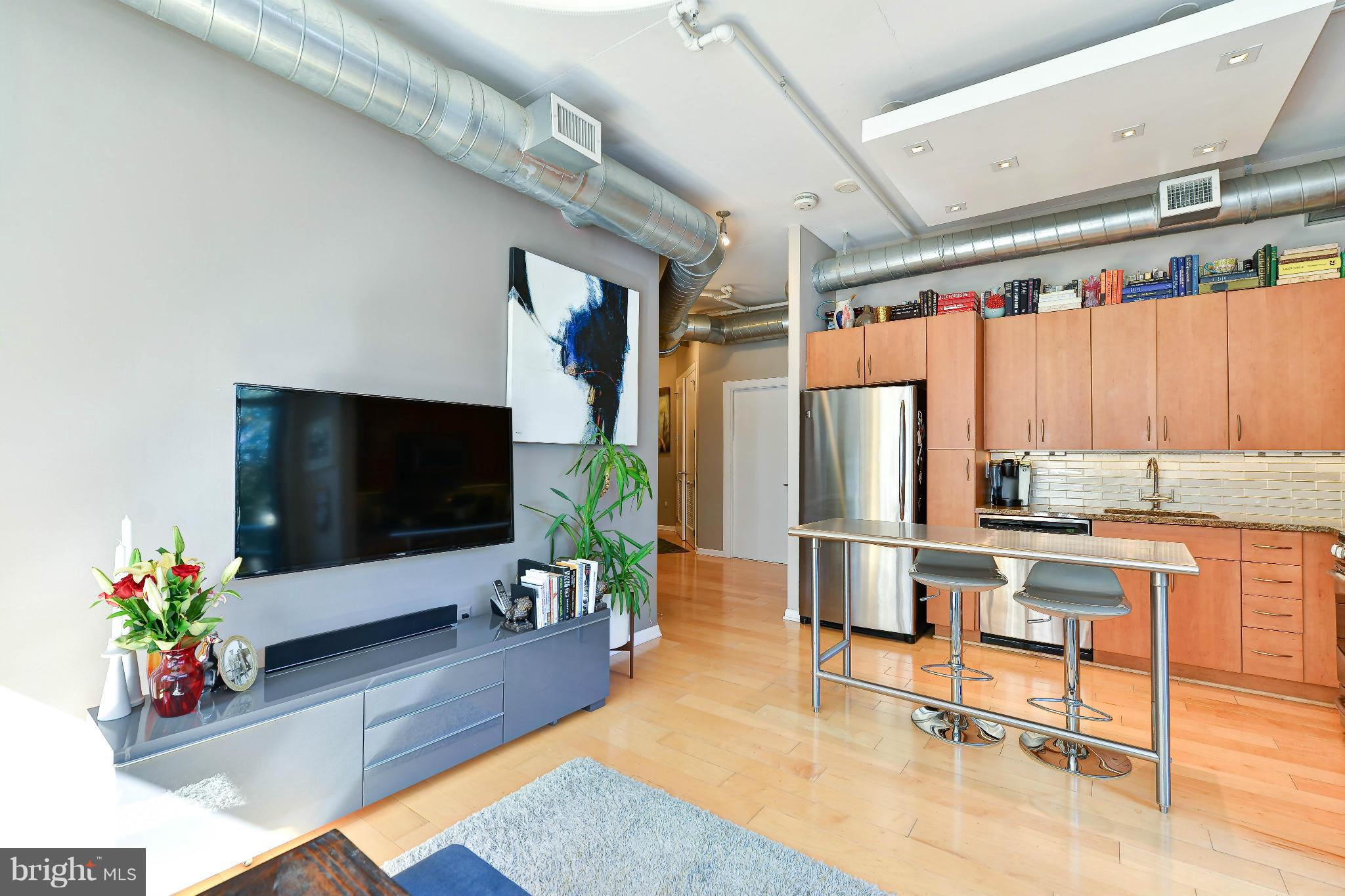 811 4th Street Northwest, Unit 218 Washington, DC 20001 - Photo 7 of 28 a living room with furniture flat screen tv and a large window