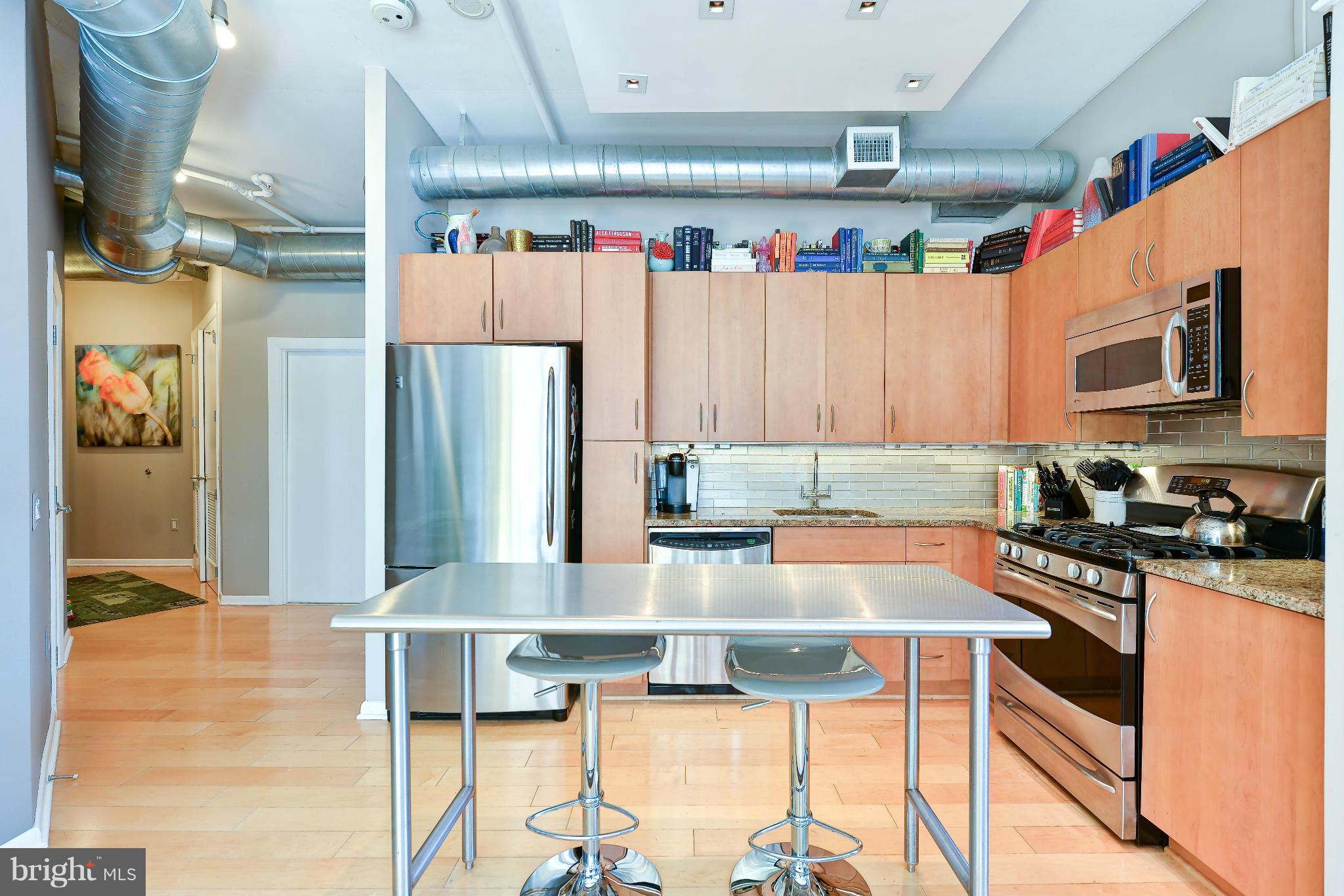 811 4th Street Northwest, Unit 218 Washington, DC 20001 - Photo 9 of 28 a kitchen with stainless steel appliances granite countertop a refrigerator and a stove