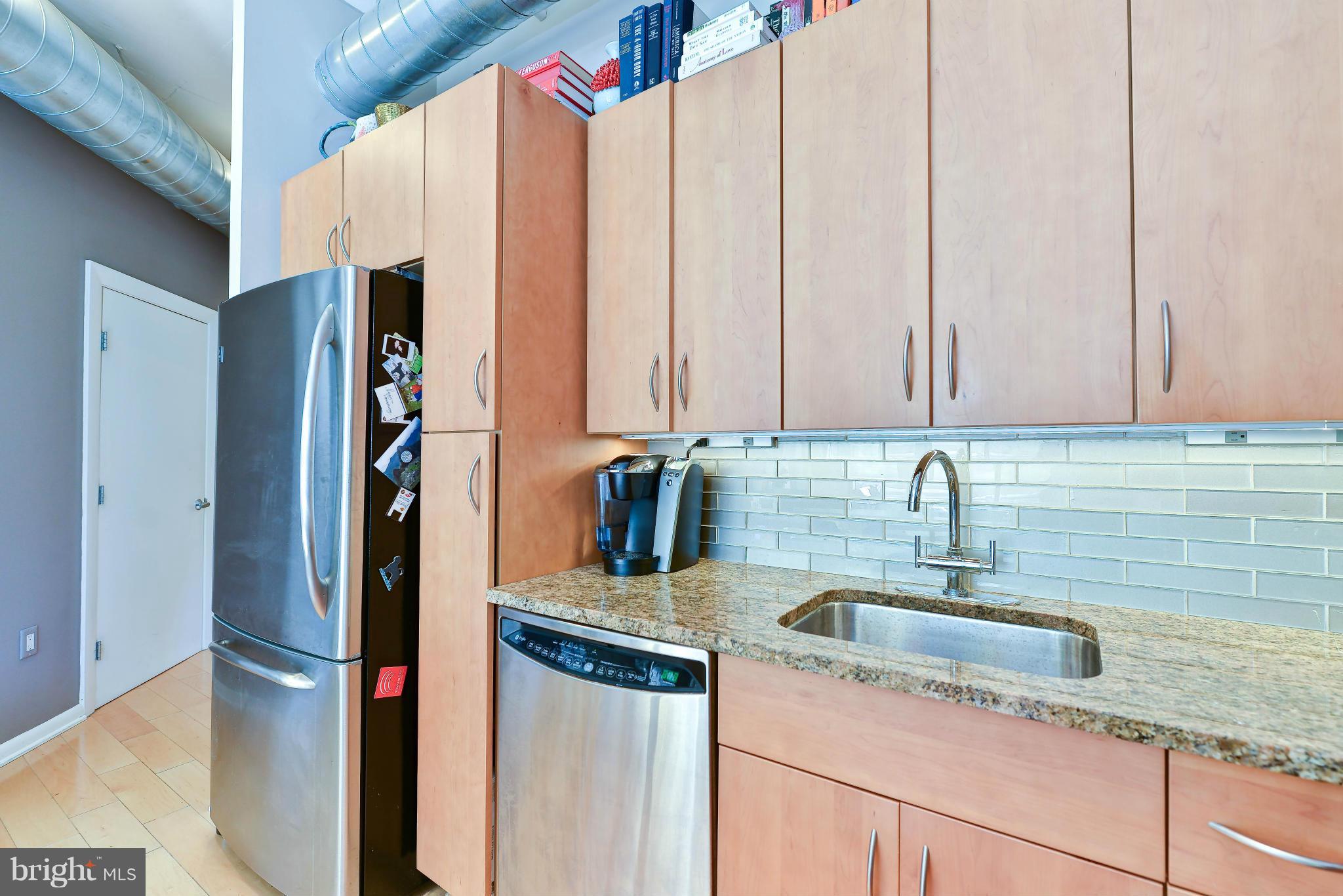 811 4th Street Northwest, Unit 218 Washington, DC 20001 - Photo 10 of 28 a kitchen with stainless steel appliances granite countertop a sink and a refrigerator