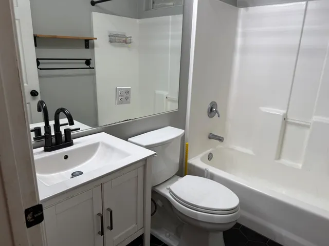 a bathroom with a sink a toilet and bathtub