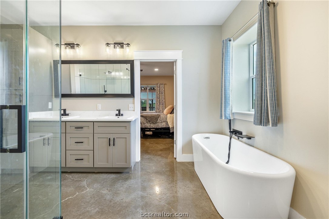 4330 Post Oak Point Road New Ulm, TX 78950 - Photo 11 of 43 a spacious bathroom with a granite countertop sink mirror and bathtub