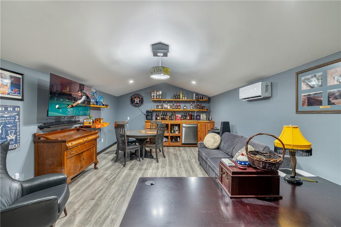 4330 Post Oak Point Road New Ulm, TX 78950 - Photo 20 of 43 a living room with fireplace furniture and a wooden floor