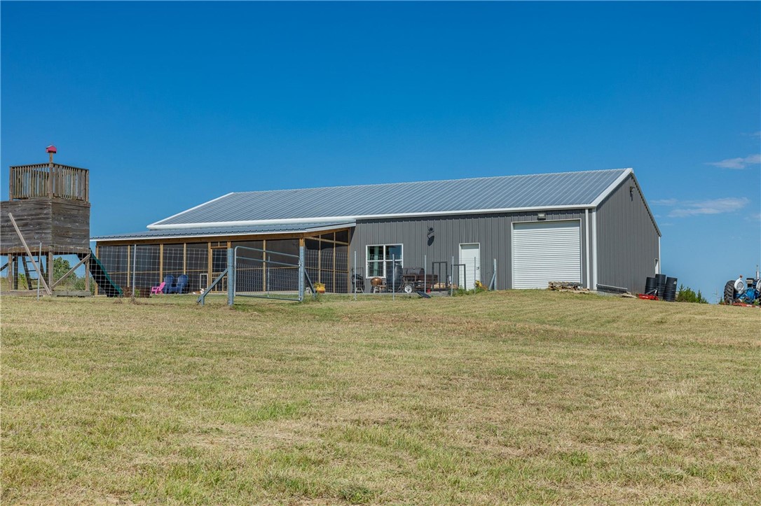 4330 Post Oak Point Road New Ulm, TX 78950 - Photo 21 of 43 a front view of a house with a garden