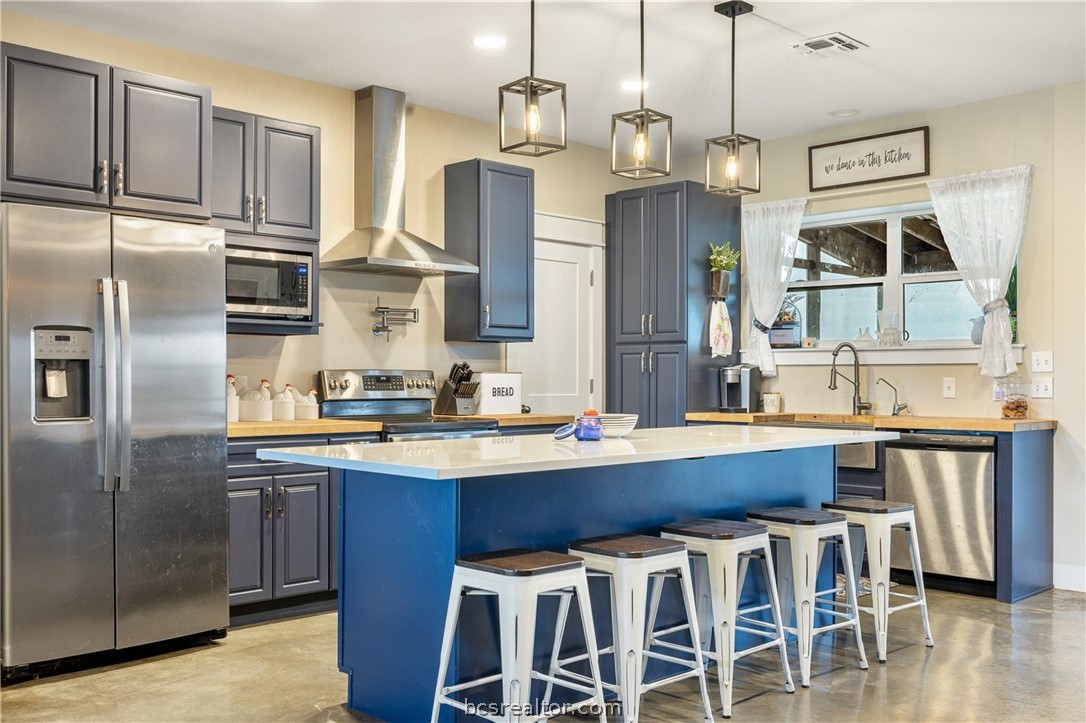 4330 Post Oak Point Road New Ulm, TX 78950 - Photo 4 of 43 a kitchen with stainless steel appliances a sink stove and refrigerator
