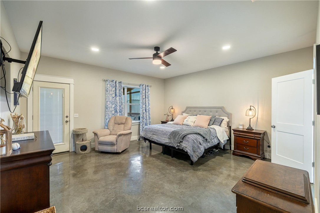 4330 Post Oak Point Road New Ulm, TX 78950 - Photo 10 of 43 a spacious bedroom with a bed and furniture
