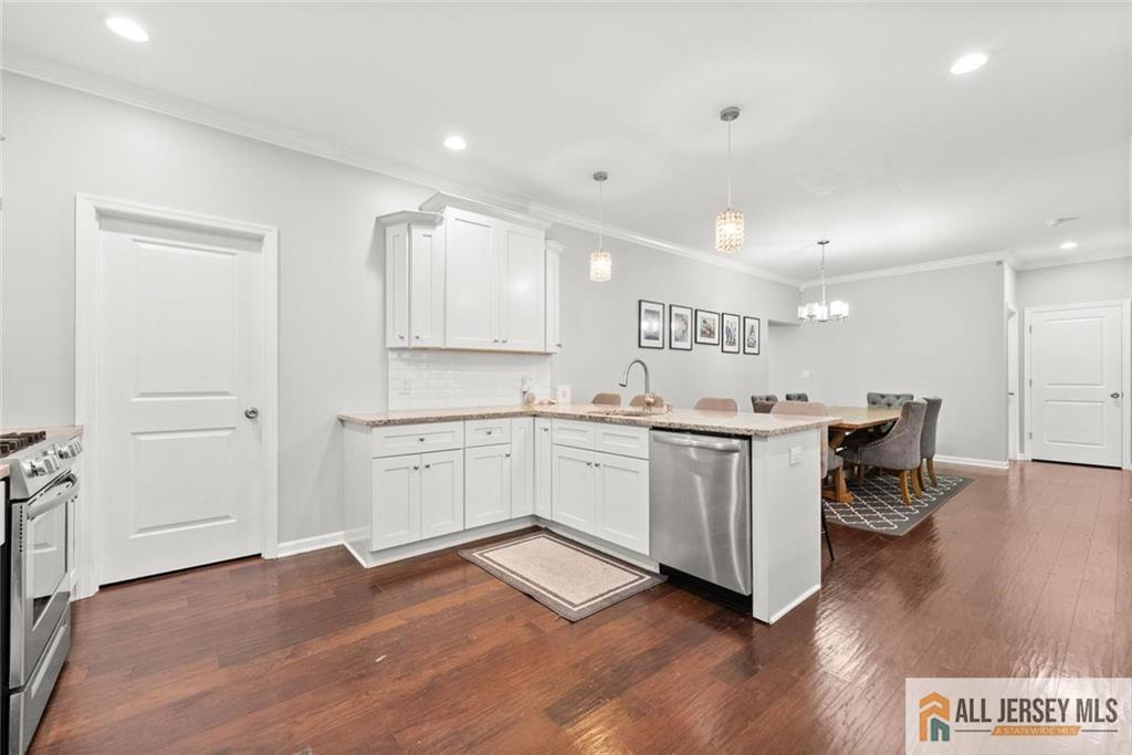 227 Temple Way Colonia, NJ 07067 - Photo 11 of 30 a open kitchen with a sink cabinets and wooden floor