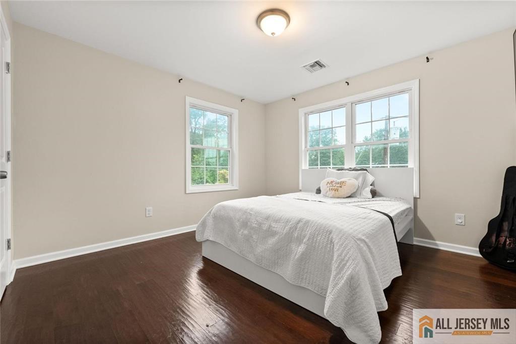 227 Temple Way Colonia, NJ 07067 - Photo 14 of 30 a bedroom with a bed and a large window