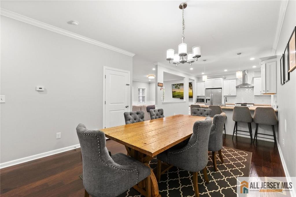 227 Temple Way Colonia, NJ 07067 - Photo 6 of 30 a view of a dining room with furniture and wooden floor