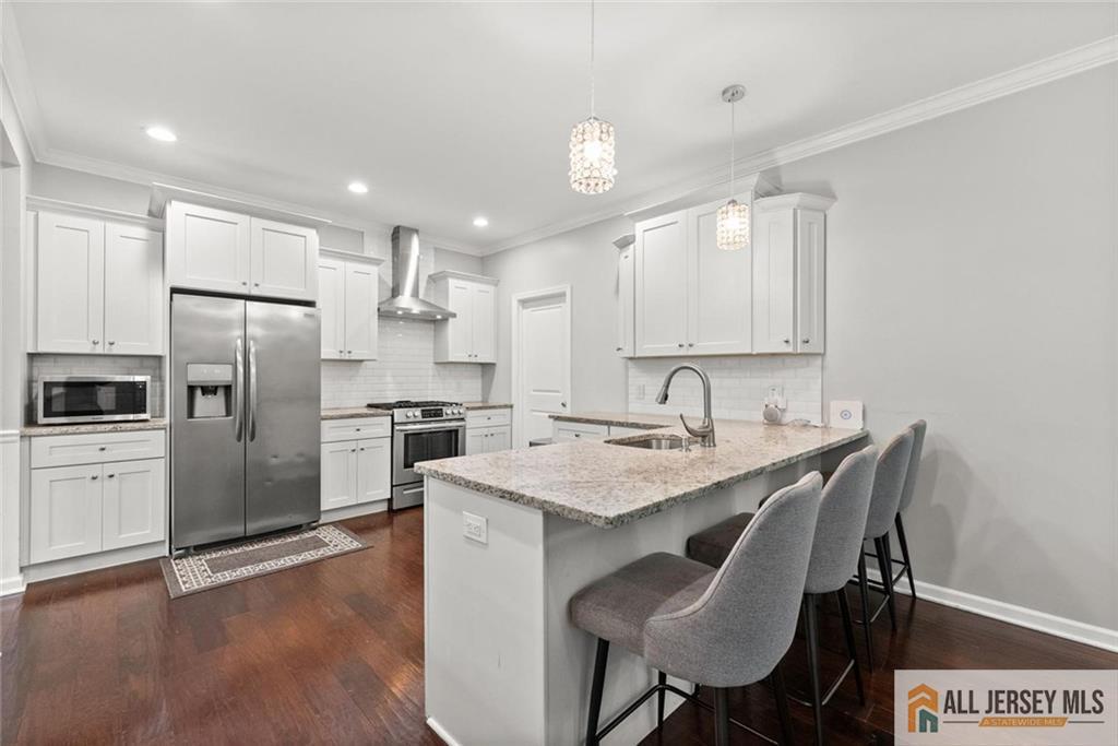 227 Temple Way Colonia, NJ 07067 - Photo 9 of 30 a kitchen with a center island appliances and cabinets