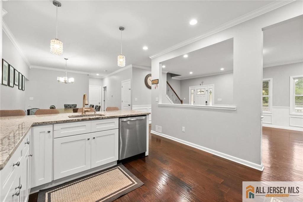 227 Temple Way Colonia, NJ 07067 - Photo 10 of 30 a large kitchen with stainless steel appliances kitchen island a large counter top and a wooden floors