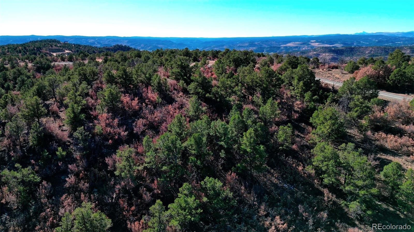 11298 Primero Ranch Trinidad, CO 81082 - Photo 25 of 36 an aerial view of a houses with a lush green hillside