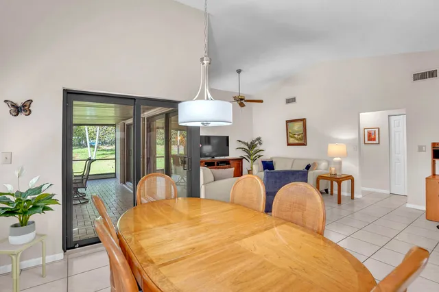 a view of a dining room with furniture and window