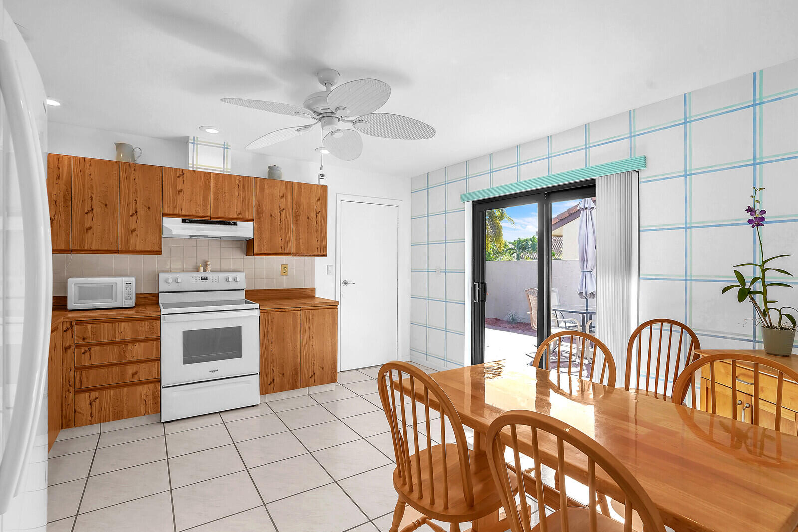 1550 Northwest 22nd Avenue Delray Beach, FL 33445 - Photo 18 of 44 a kitchen with granite countertop a stove a sink and a refrigerator
