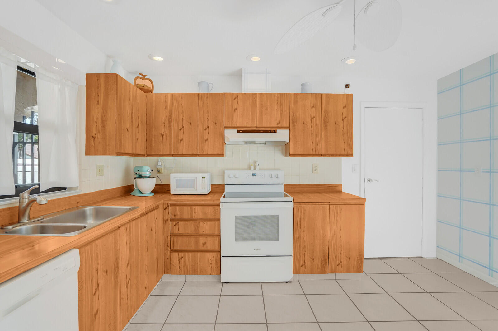 1550 Northwest 22nd Avenue Delray Beach, FL 33445 - Photo 19 of 44 a kitchen with stainless steel appliances granite countertop a sink and a stove