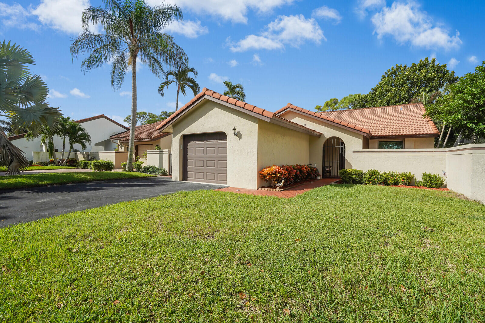 1550 Northwest 22nd Avenue Delray Beach, FL 33445 - Photo 2 of 44 a front view of a house with a garden