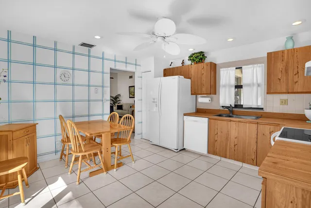 a kitchen with stainless steel appliances a refrigerator and microwave