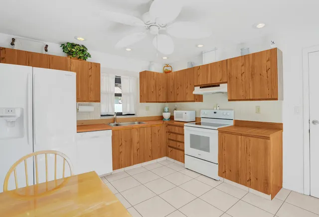 a kitchen with stainless steel appliances granite countertop a refrigerator sink and cabinets