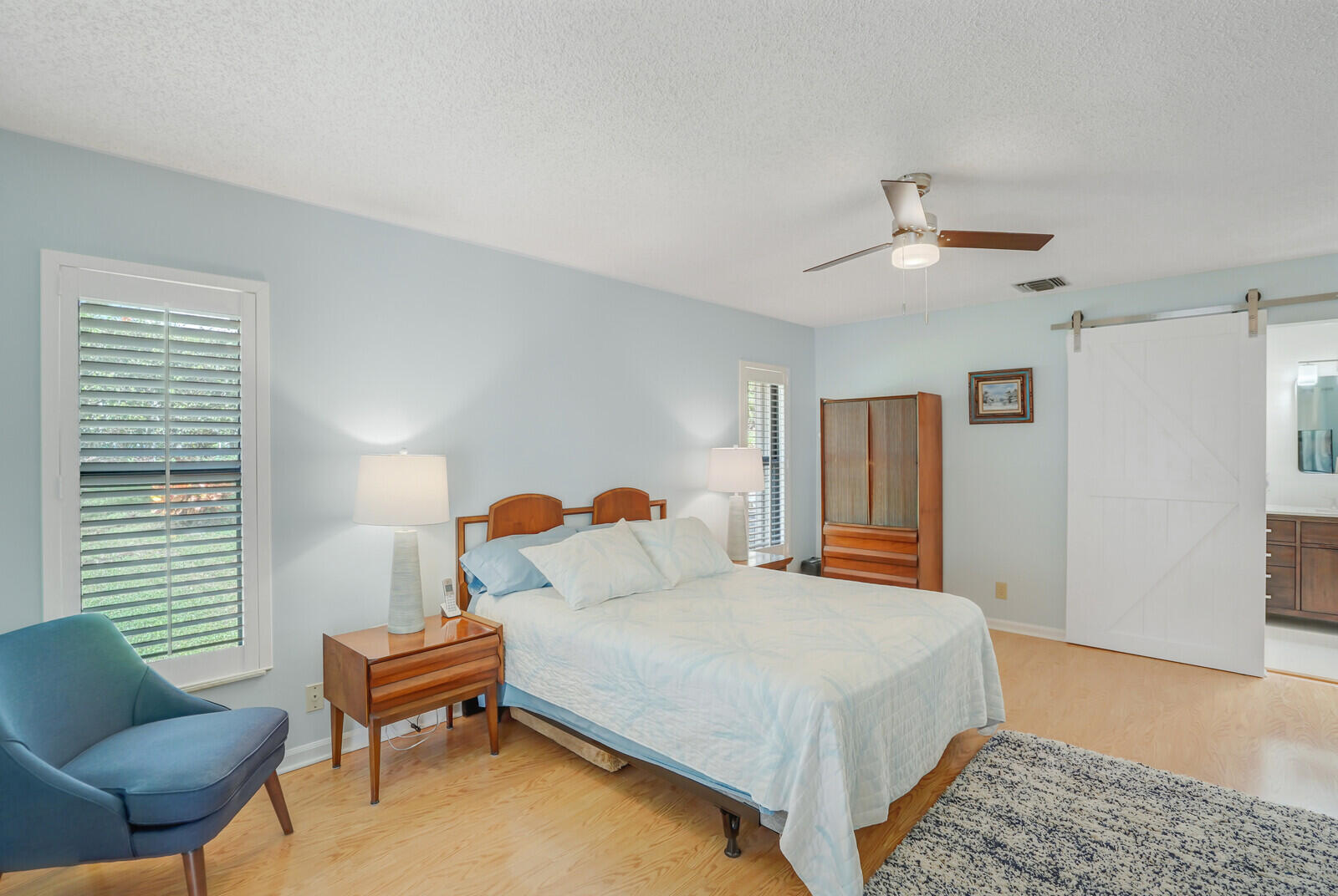 1550 Northwest 22nd Avenue Delray Beach, FL 33445 - Photo 28 of 44 a bedroom with a bed and a couch