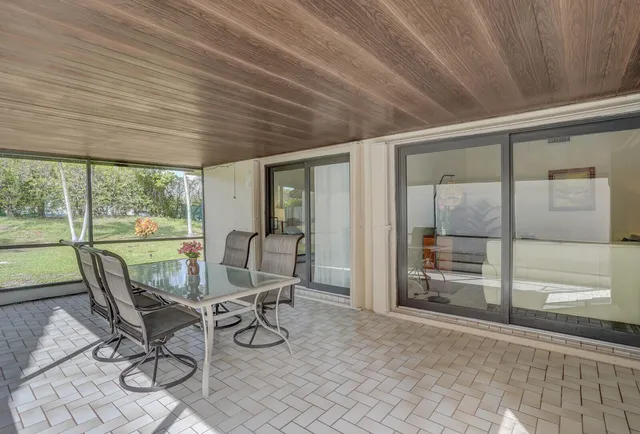 a view of a dining room with furniture wooden floor and next to a window