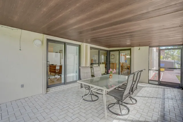a view of a patio with table and chairs