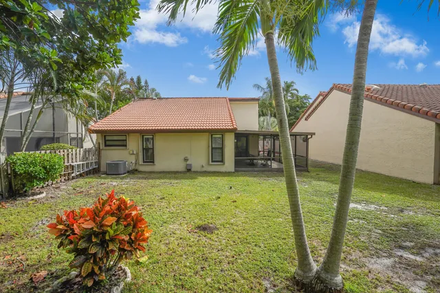 a view of a house with pool and garden