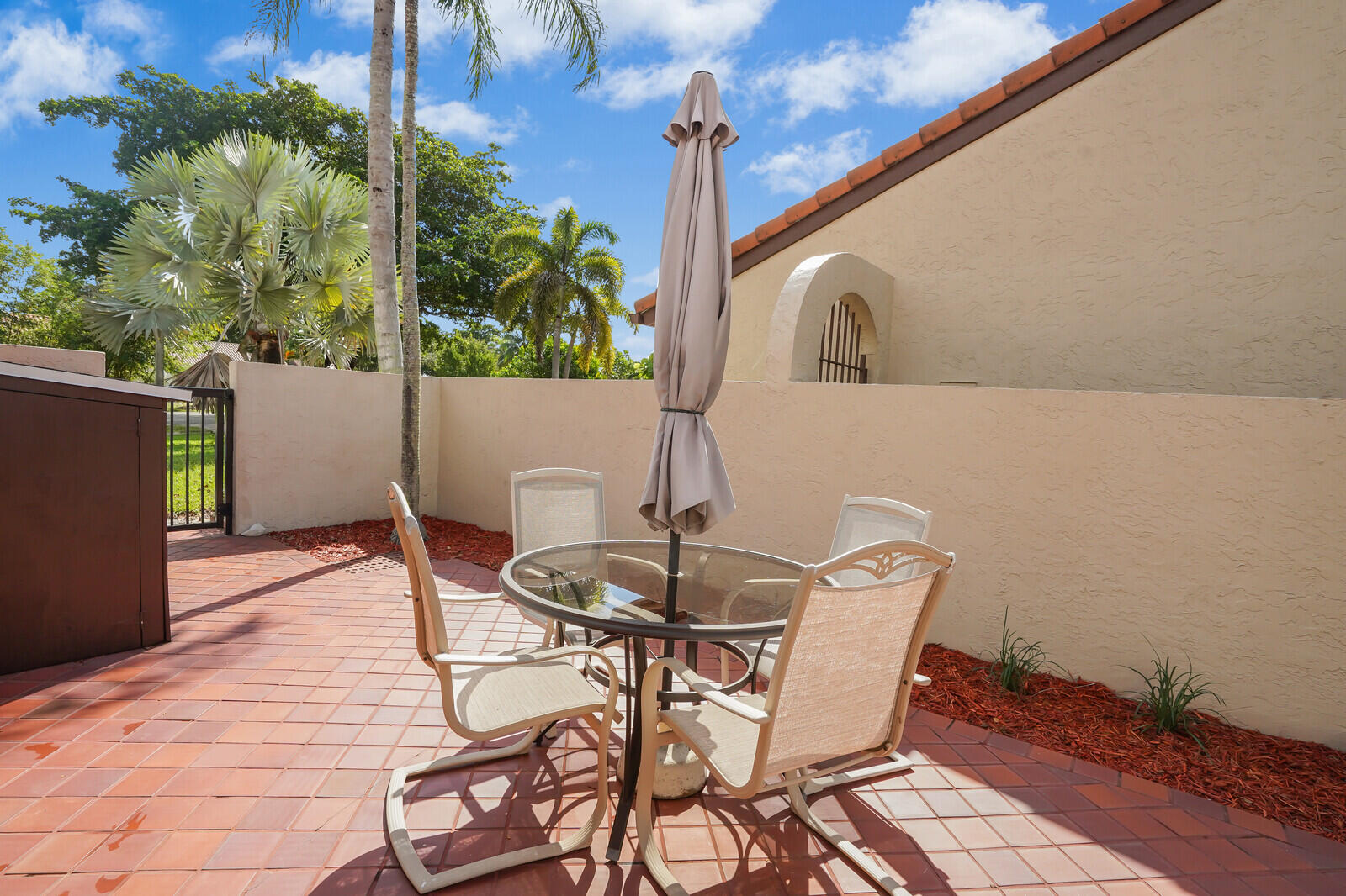 1550 Northwest 22nd Avenue Delray Beach, FL 33445 - Photo 40 of 44 a table and chairs in front of a door