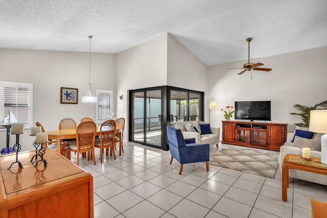 a living room with furniture a flat screen tv and a window