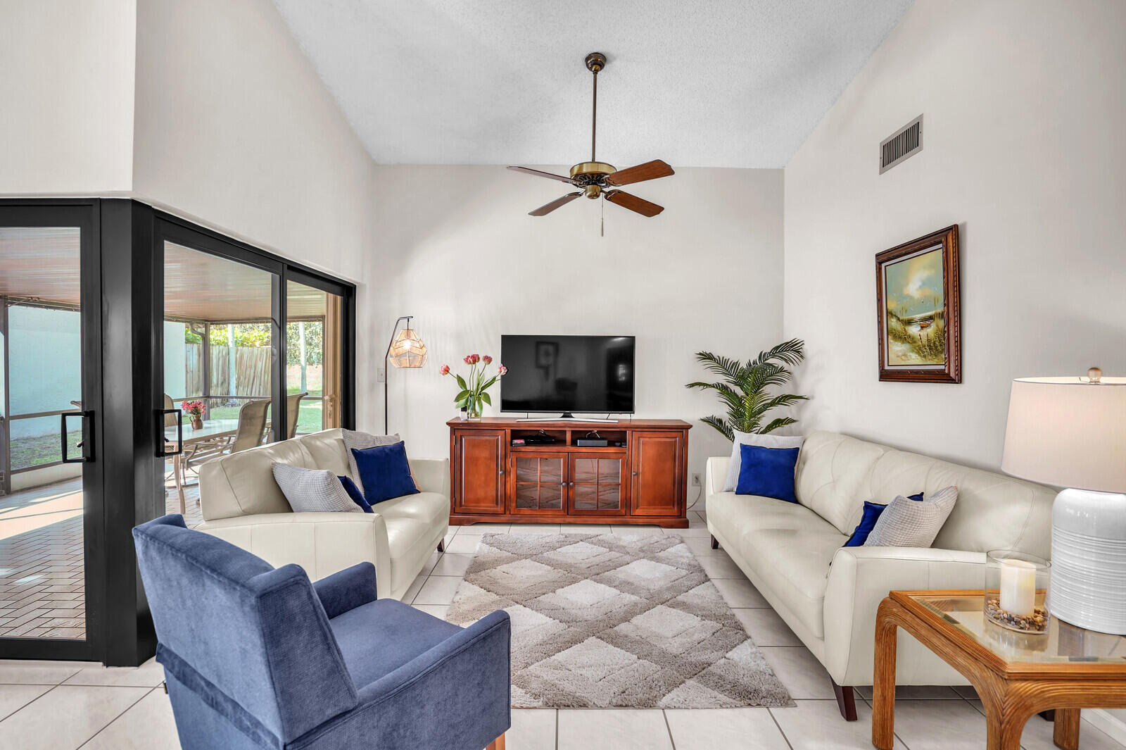 1550 Northwest 22nd Avenue Delray Beach, FL 33445 - Photo 10 of 44 a living room with furniture a flat screen tv and a window