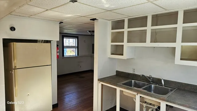 a kitchen with a refrigerator and a sink