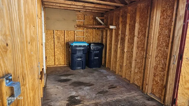 a view of a utility room with wooden walls