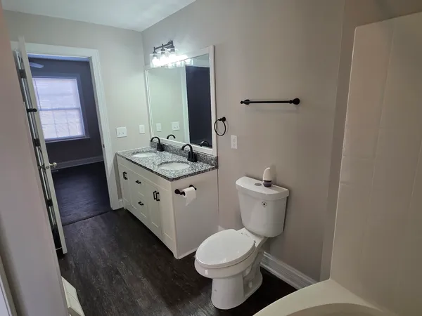 a bathroom with a toilet sink and mirror
