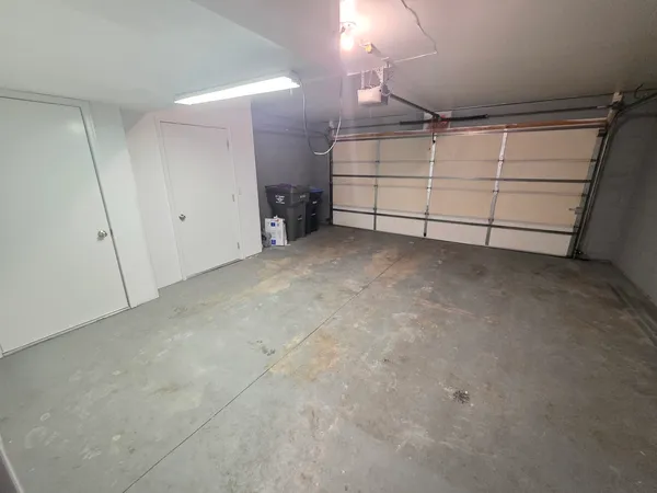 an empty room with closet and windows