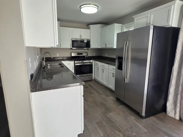 a kitchen with a refrigerator sink and microwave