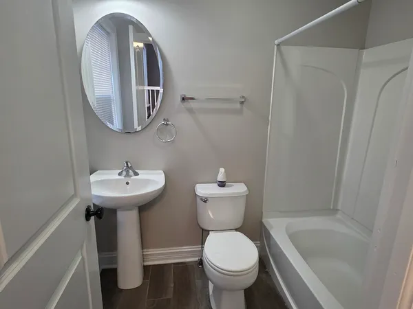 a bathroom with a sink toilet and a mirror