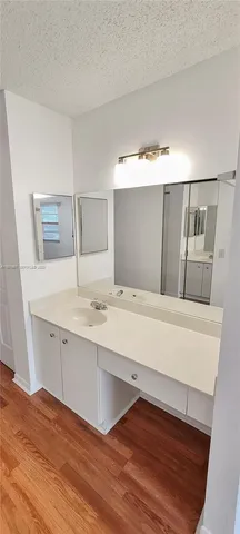 a bathroom with a sink and mirror