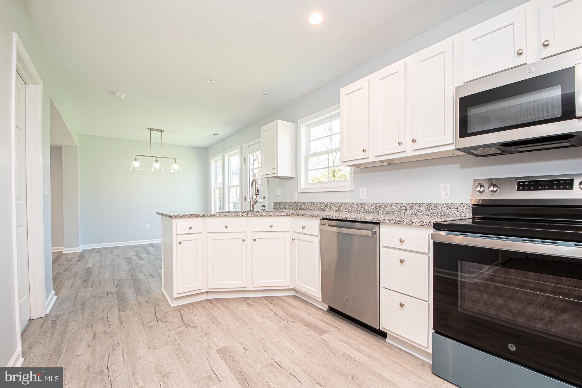 709 Ross Street Winchester, VA 22601 - Photo 18 of 40 a kitchen with granite countertop a sink cabinets and stainless steel appliances