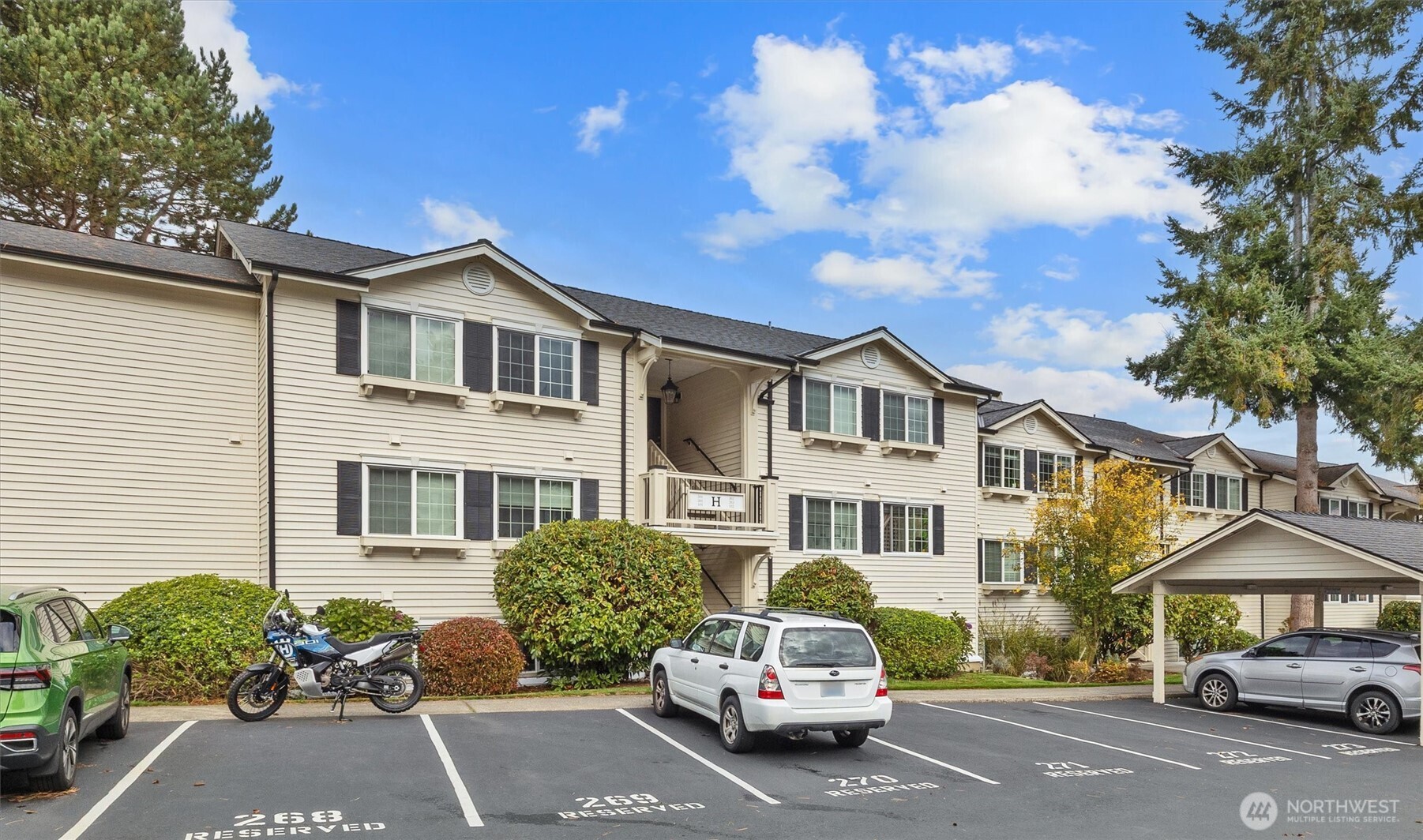 12404 East Gibson Road, Unit H301 Everett, WA 98204 - Photo 1 of 36 a white house covered with tall trees