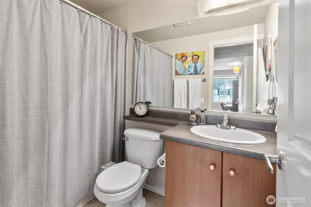 a bathroom with a toilet a sink and a mirror