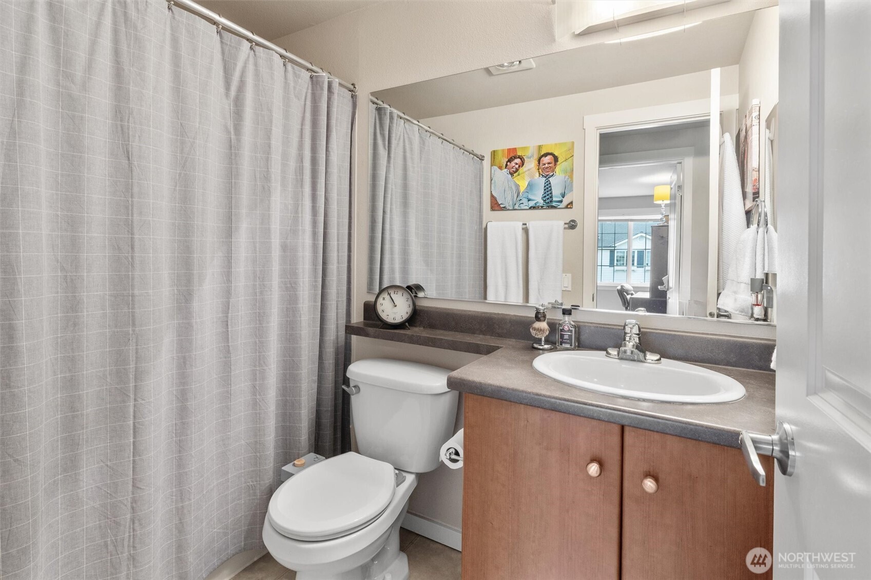 12404 East Gibson Road, Unit H301 Everett, WA 98204 - Photo 16 of 36 a bathroom with a toilet a sink and a mirror