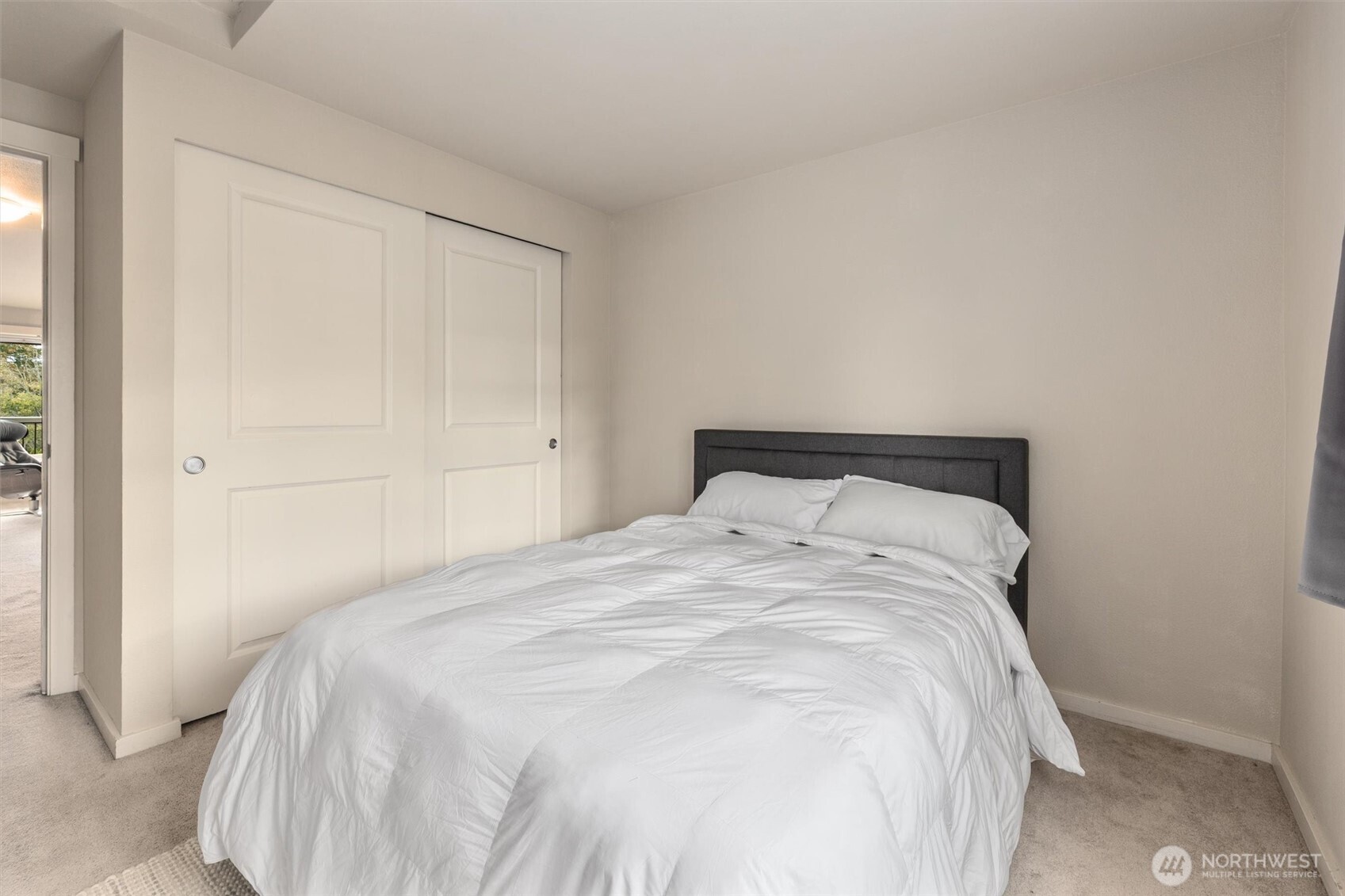 12404 East Gibson Road, Unit H301 Everett, WA 98204 - Photo 23 of 36 a large bed sitting in a bedroom next to a window