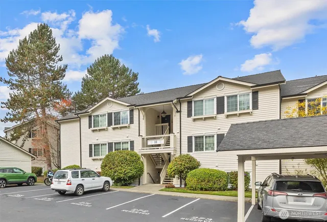 a car parked in front of a white house